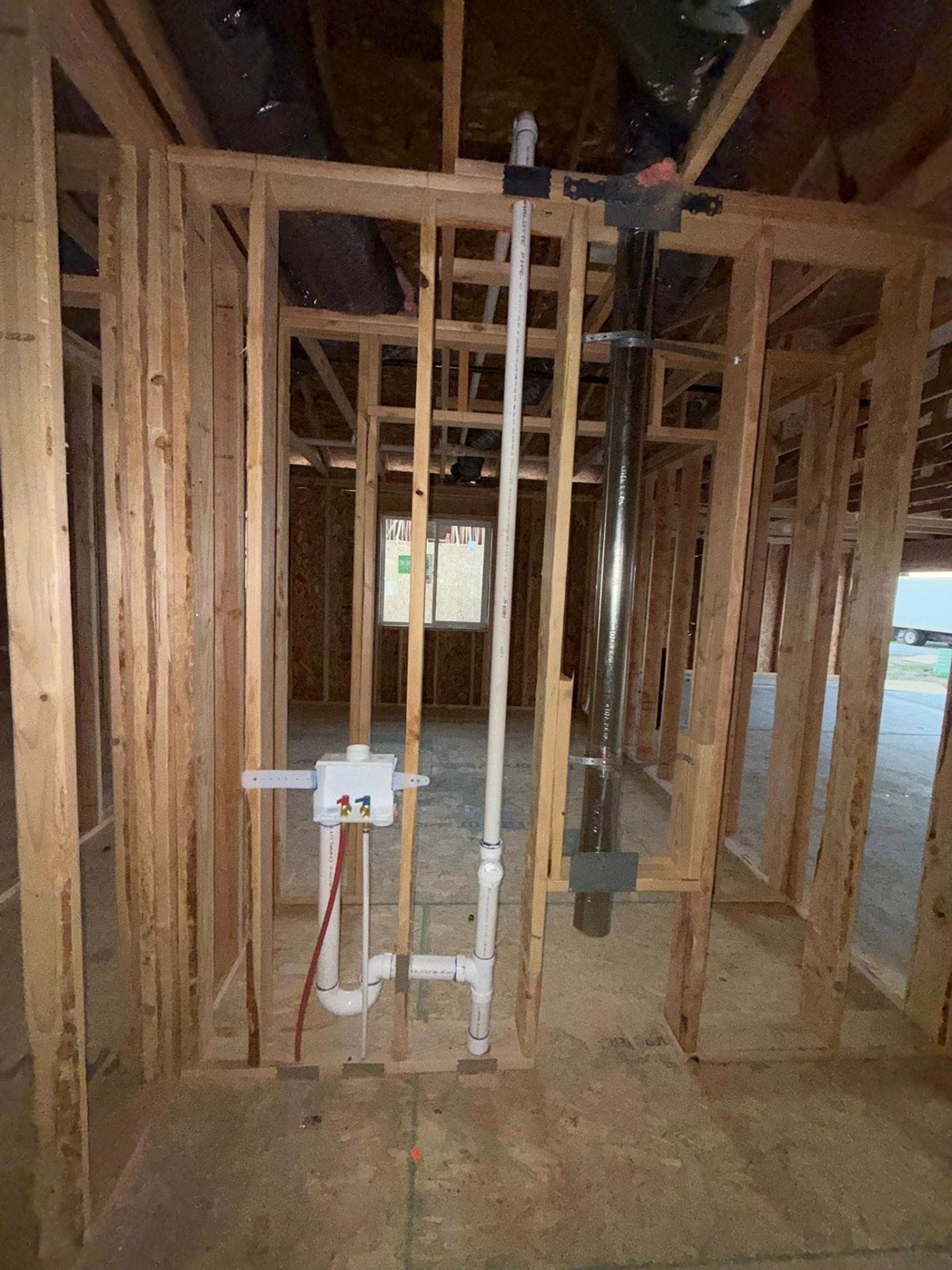 Framed-in laundry rough plumbing with PEX and DWV stack