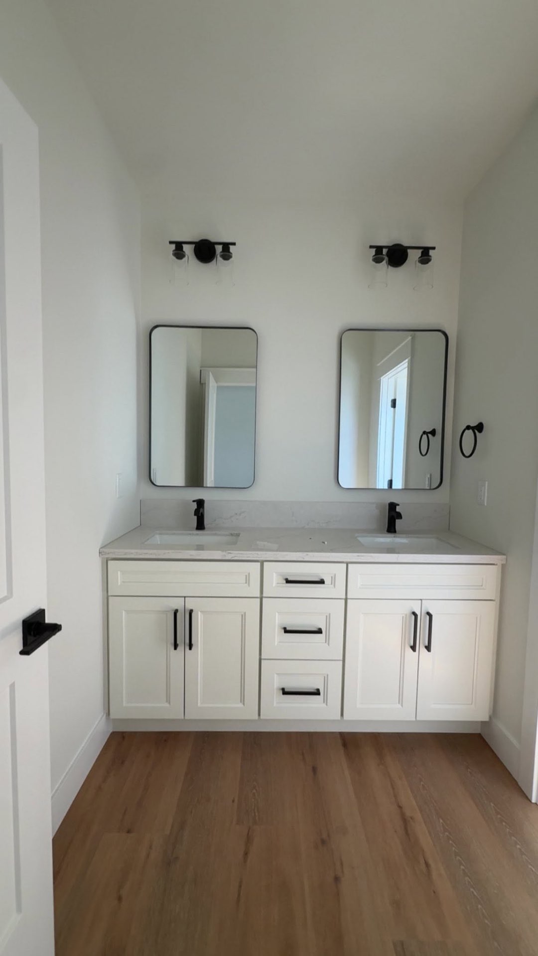 Custom double-vanity bathroom remodel with matte black fixtures