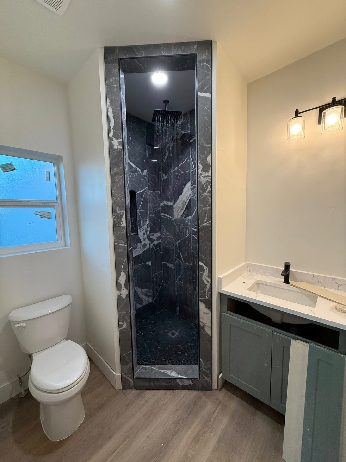 Luxury black marble walk-in shower with rain head